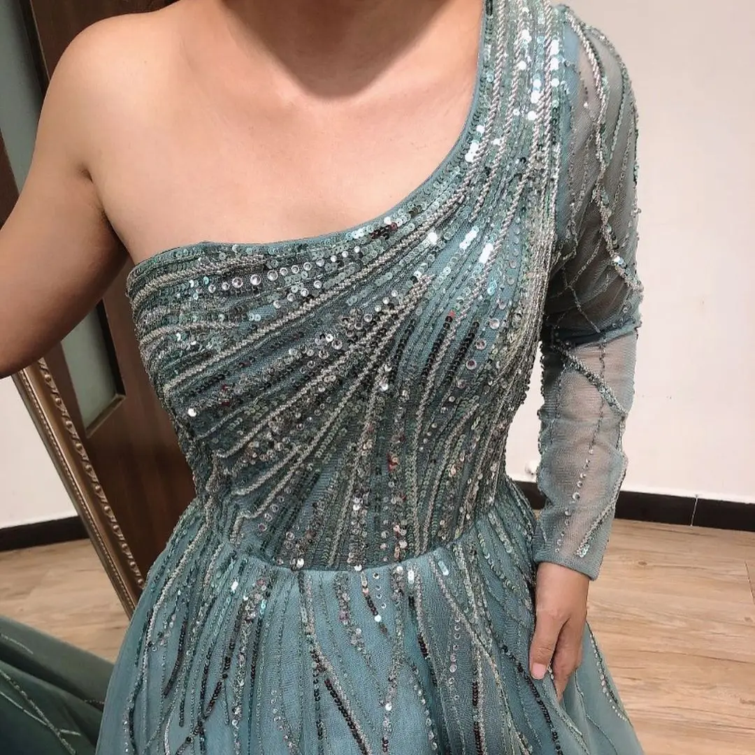 

FATAPAESE Glimmering Lace Ballgown with a Off-Shoulder features an Embellished Bodice and Modest Coverage Floor Length Gown