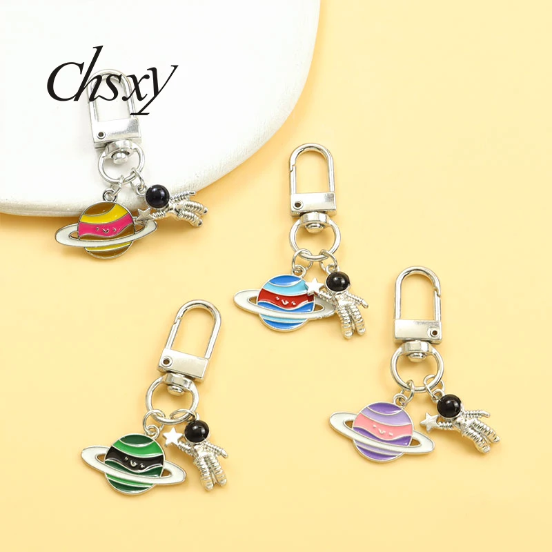 

Cartoon Colorful Planet Enamel Keychain Cute Astronaut Alloy Charms Pendant Key Ring For Handbag Earphone Case Popular Ornaments