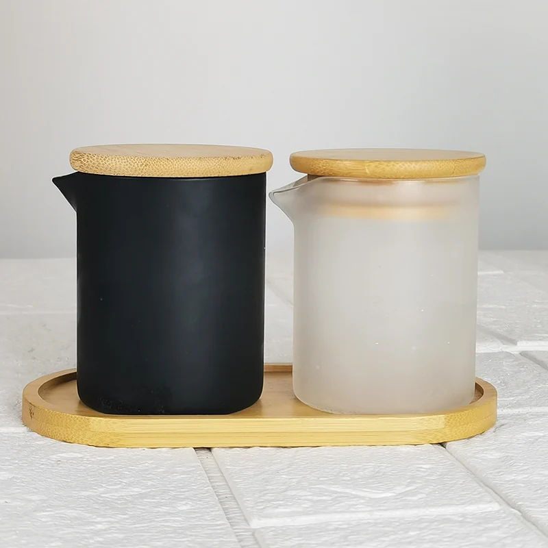 

Home Usage Glass Sand Blasting Storage Tank White and Black Candle Making Jars with Bamboo Tray Massage Oil Container with Spout