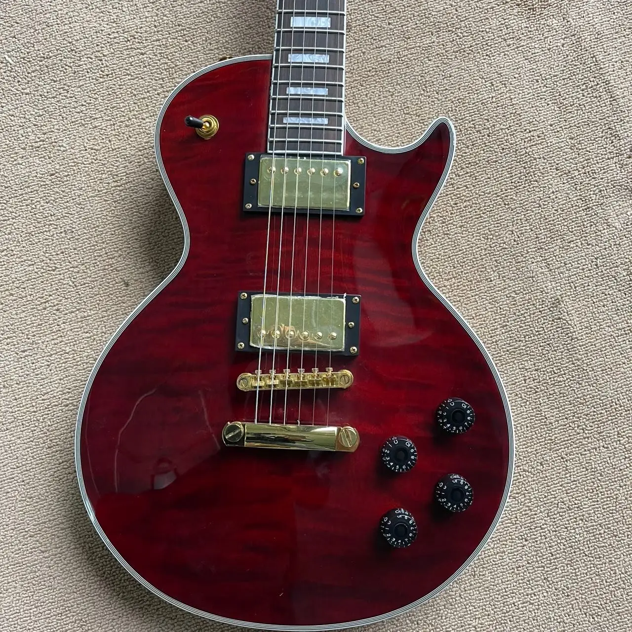 

LP all-in-one electric guitar, wine red transparent tiger pattern veneer mahogany, LP pickup, LP string bridge, rosewood fingerb