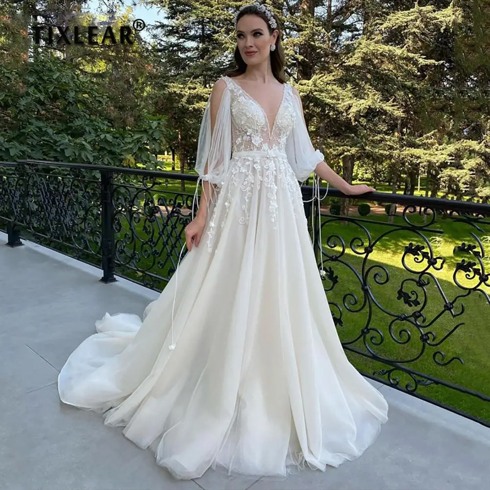 

TIXLEAR Fairy Boho A Line V Neck Tulle Wedding Dress Beaded 3/4 Sleeves Backless Lace Appliques Sashes Sweep Train Bride Gowns