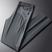 Брюки мужские эластичные с завышенной талией, модные повседневные однотонные брюки из газовой ткани с карманами и надписями, осень-весна