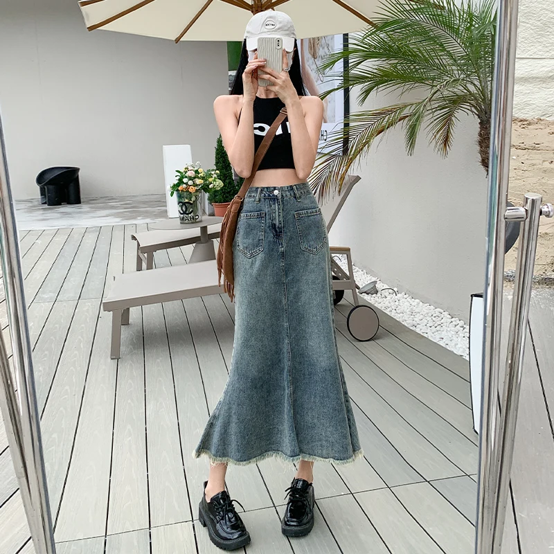 Denim skirt women's summer blue long skirt commuting new 2023 Korean version high waist niche loose bag hip raw edge fishtail