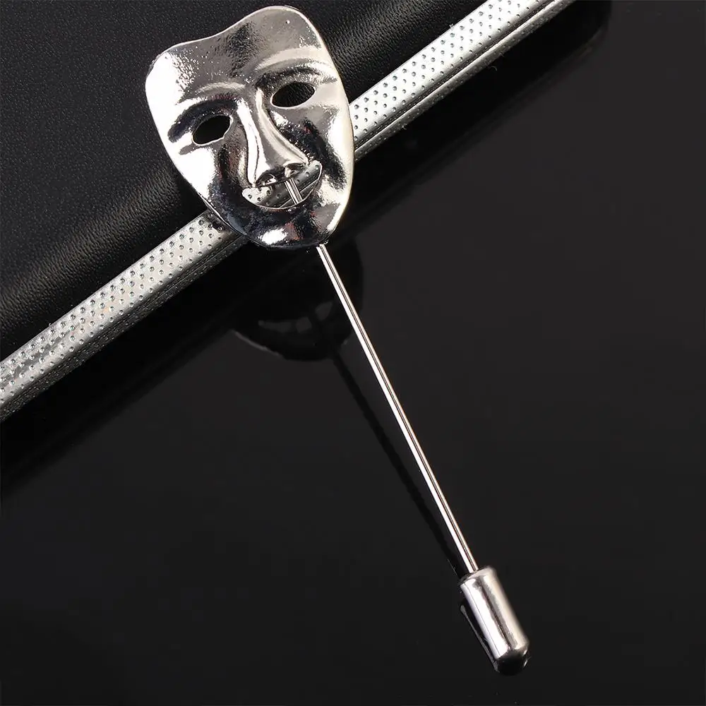 Золотая брошь маска