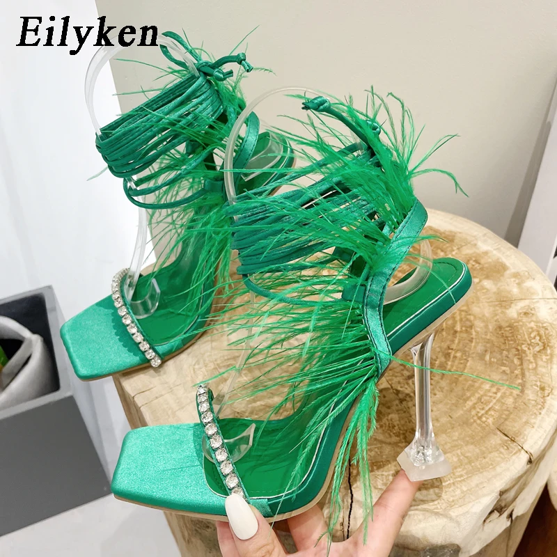 Eilyken New Design Womens Sandals Fashion Fuzzy Feather Summer Transparent High Heels Sexy Nightclub Stripper Shoes Purple Green