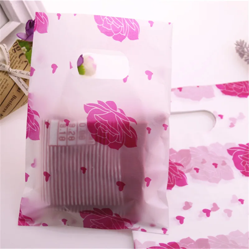 

Hot Sale Wholesale 100pcs/lot 15*20cm Hot Pink Plastic Lovely Rose Flower Shopping Bags Favor Party Gift Packaging