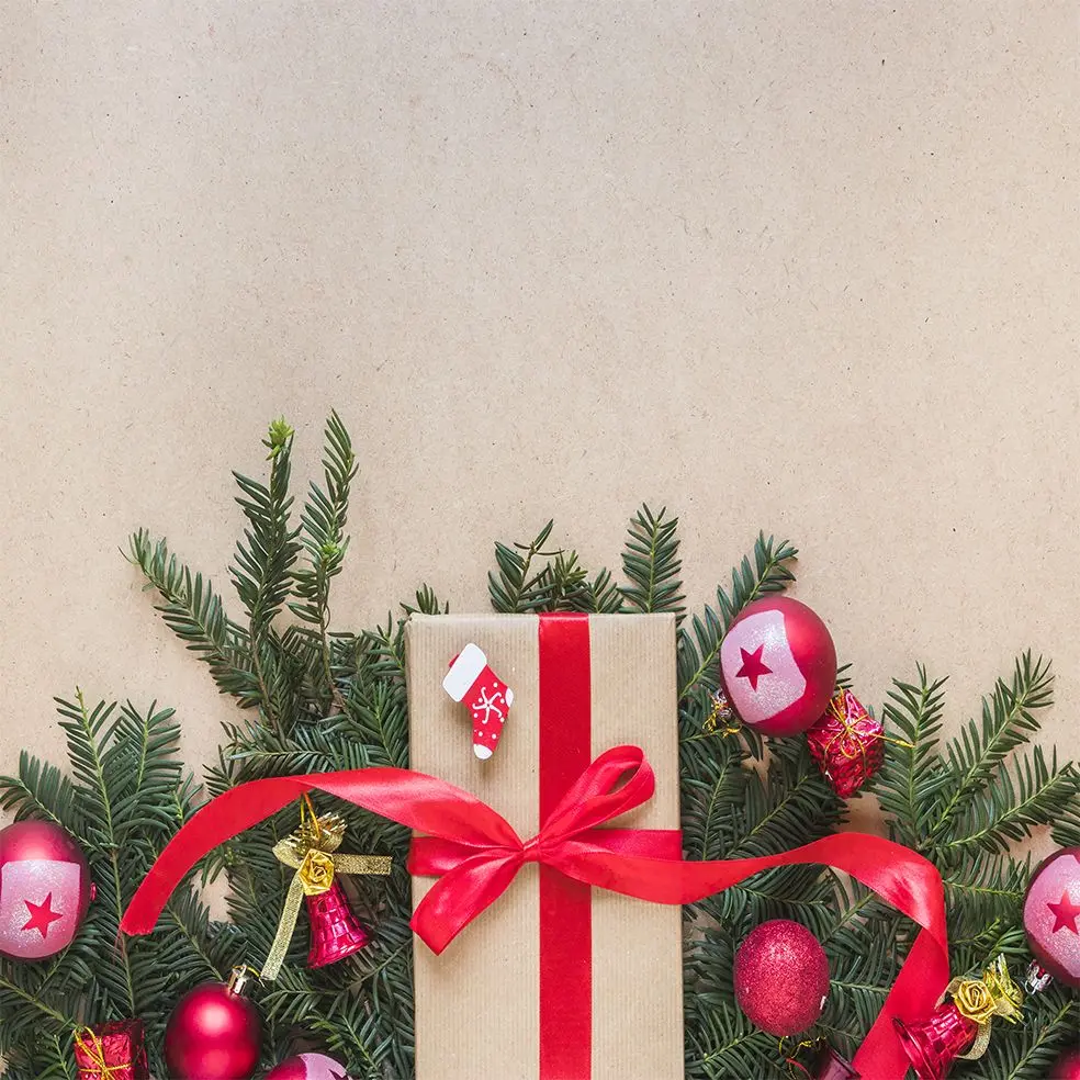 

Curtain Wrapped Gifts Ornaments Baubles Socks Bells on Pine Tree Branches Christmas Theme Photo Brown White Green