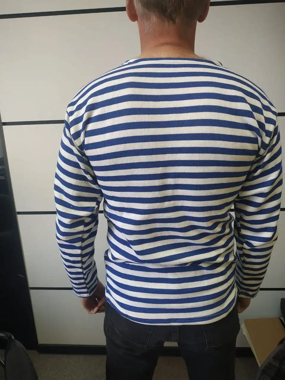 A vest with a fleece on bike cotton blue and black strip. |