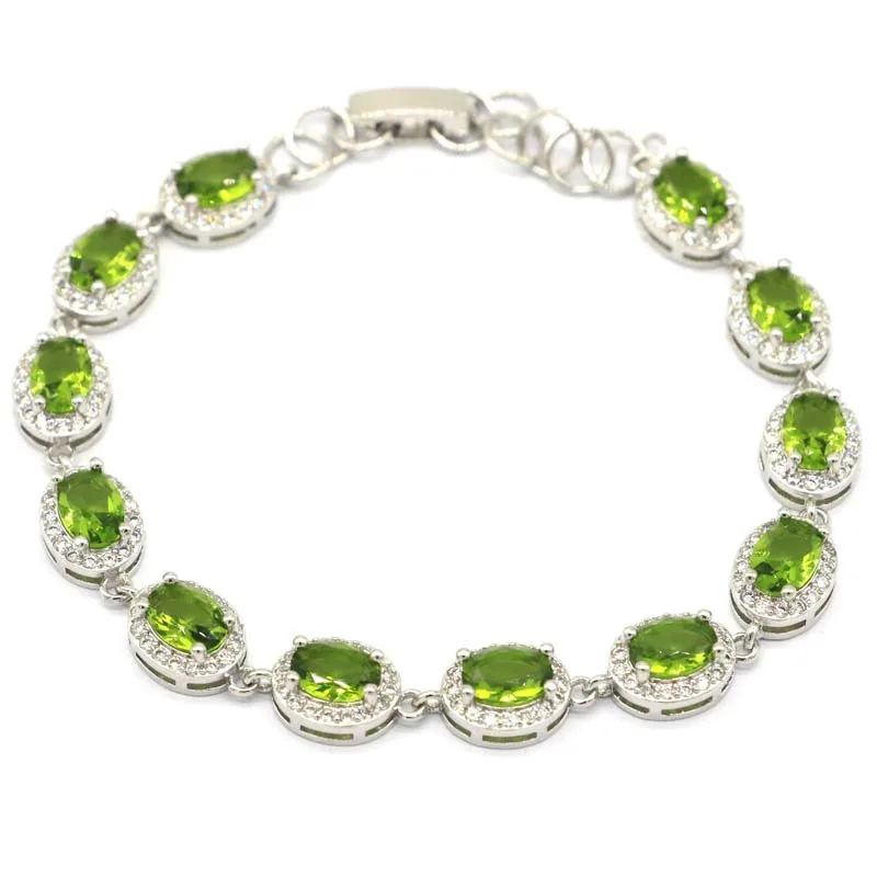 Женский серебряный браслет 14 х8 мм украшенный зеленым Перидотом насыщенный синим